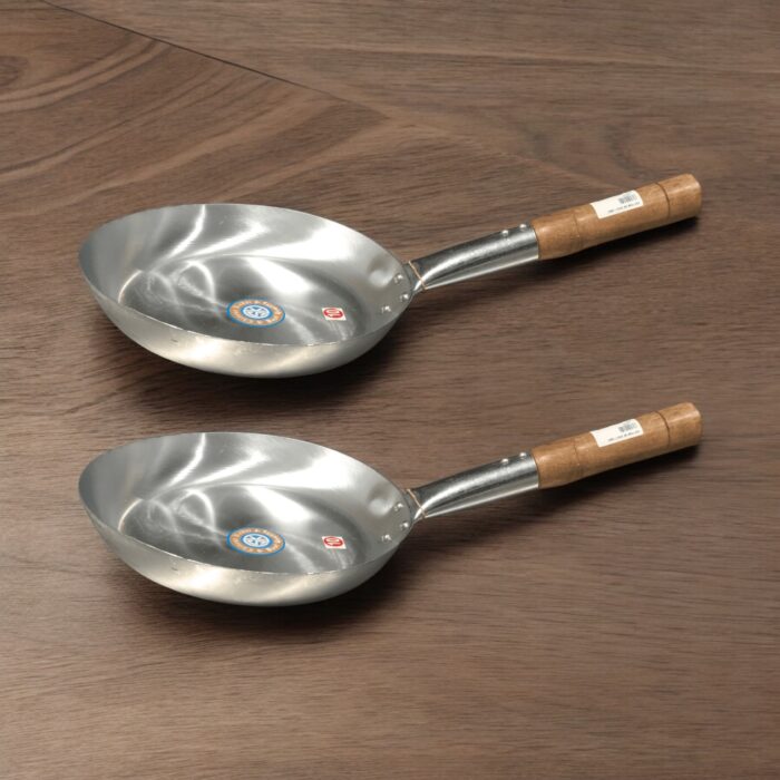 SK Flat Iron Frying Pan with a sleek wooden handle, available in 10, 11, 12, and 13-inch sizes, perfect for versatile cooking
