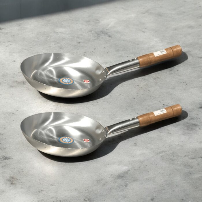 SK Flat Iron Frying Pan with a sleek wooden handle, available in 10, 11, 12, and 13-inch sizes, perfect for versatile cooking