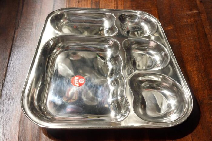 Raj 5-in-1 Apple Shape Bhojan Thal Set of Two featuring a sleek apple-shaped design, five compartments, and premium stainless steel.