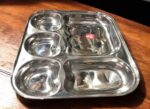 Raj 5-in-1 Apple Shape Bhojan Thal Set of Two featuring a sleek apple-shaped design, five compartments, and premium stainless steel.