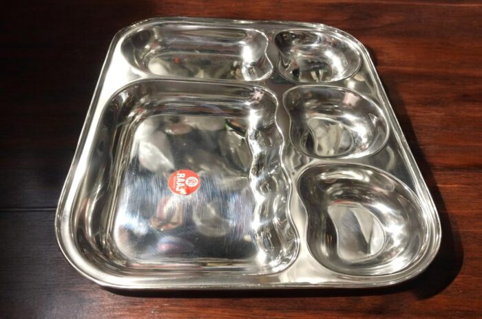 Raj 5-in-1 Apple Shape Bhojan Thal Set of Two featuring a sleek apple-shaped design, five compartments, and premium stainless steel.