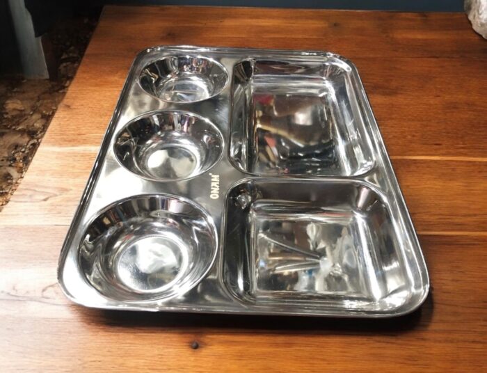 Onam 5-in-1 Bhojan Thal with round design, deep compartments, and heavy-gauge stainless steel for a premium dining experience.