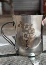 Mayur Gold Signature Stainless Steel Cup Set with a gold flower design, 250 ml capacity per cup, set of 4