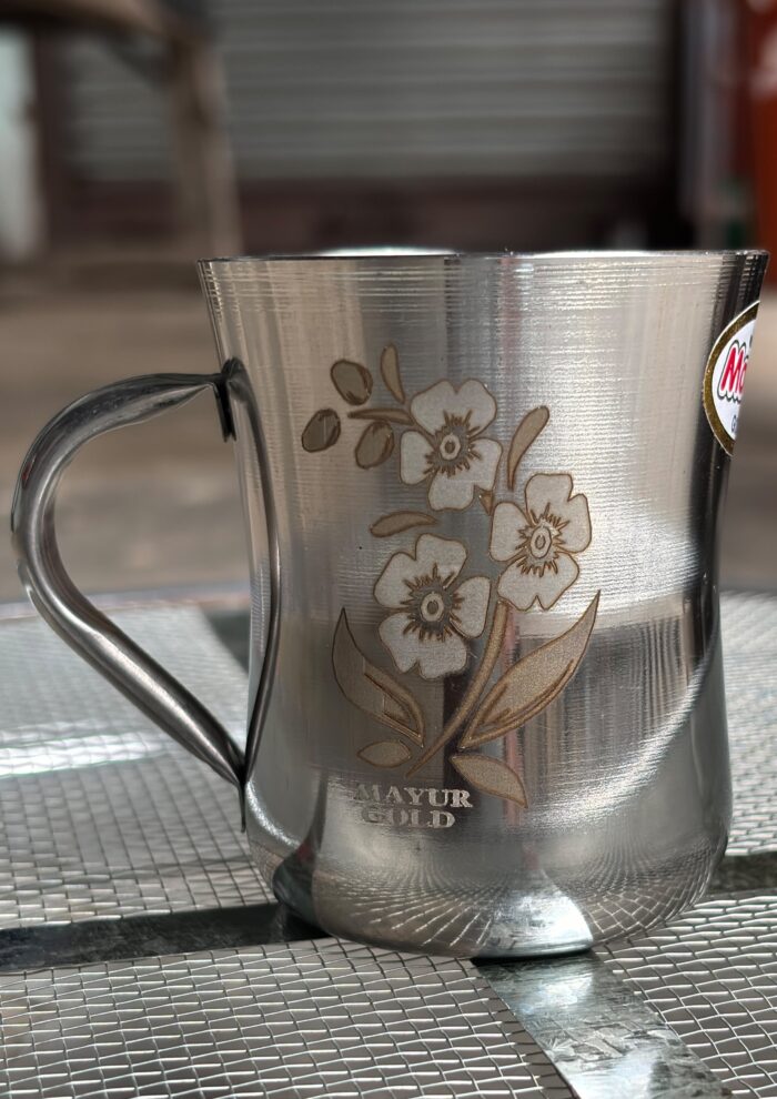 Mayur Gold Signature Stainless Steel Cup Set with a gold flower design, 250 ml capacity per cup, set of 4