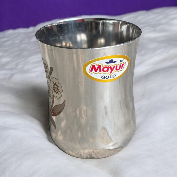 Mayur Gold Signature Stainless Steel Cup Set with a gold flower design, 250 ml capacity per cup, set of 4
