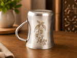 Mayur KM Gold Signature Stainless Steel Cup Set of 4 with elegant gold floral design and mirror-polished finish. Premium 250ml food-grade stainless steel tea and coffee cups for home, dining, gifting, and special occasions.