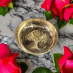 A handcrafted 5-inch WellnessCarve Bronze Cherry Plate, featuring a smooth finish and elegant design, perfect for serving and enhancing traditional dining experiences.