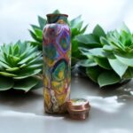 Beautifully engraved copper bottle with two matching floral design glasses, promoting health benefits like improved digestion and detoxification.