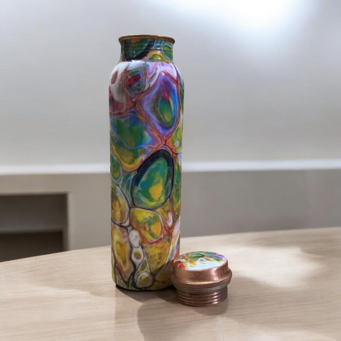 Beautifully engraved copper bottle with two matching floral design glasses, promoting health benefits like improved digestion and detoxification.