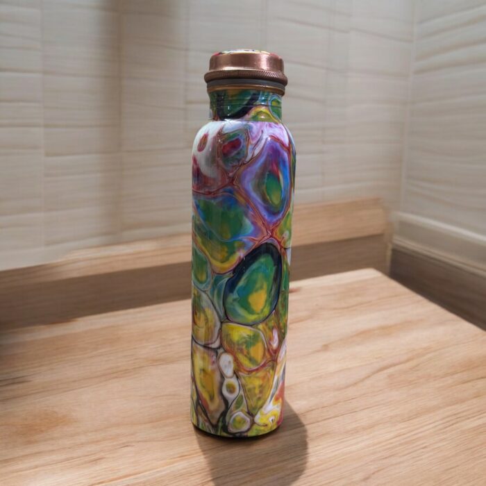 Beautifully engraved copper bottle with two matching floral design glasses, promoting health benefits like improved digestion and detoxification.