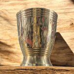 A premium Mayur Regal Sip Brass Tumbler Set (300 ml, Set of Two) with an intricate floral design, crafted for weddings, festive occasions, and luxury gifting.