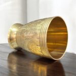 A premium Mayur Regal Sip Brass Tumbler Set (300 ml, Set of Two) with an intricate floral design, crafted for weddings, festive occasions, and luxury gifting.