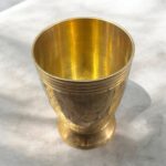 A premium Mayur Regal Sip Brass Tumbler Set (300 ml, Set of Two) with an intricate floral design, crafted for weddings, festive occasions, and luxury gifting.
