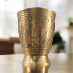A premium Mayur Regal Sip Brass Tumbler Set (300 ml, Set of Two) with an intricate floral design, crafted for weddings, festive occasions, and luxury gifting.
