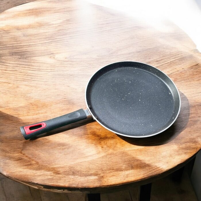 Top view of Pooja 25 cm hard anodized dosa tawa with induction base, featuring a thick 2.8 mm non-stick surface and ergonomic handle.