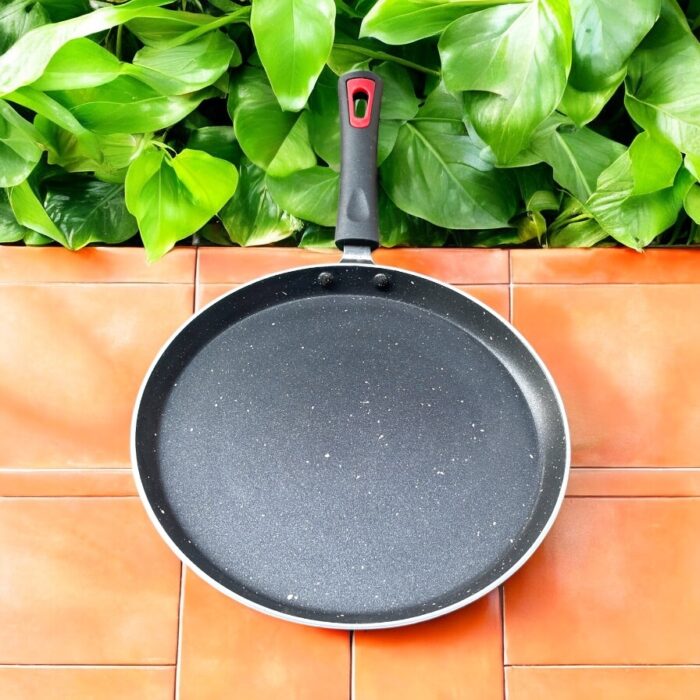 Top view of Pooja 25 cm hard anodized dosa tawa with induction base, featuring a thick 2.8 mm non-stick surface and ergonomic handle.