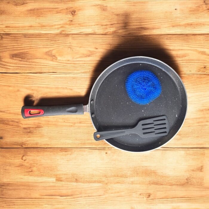 Top view of Pooja 25 cm hard anodized dosa tawa with induction base, featuring a thick 2.8 mm non-stick surface and ergonomic handle.