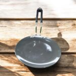Close-up of Onam 220 mm non-stick roti tawa with induction-compatible base and thick 4.06 mm body, ideal for compact kitchens.