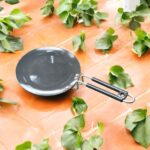 Close-up of Onam 220 mm non-stick roti tawa with induction-compatible base and thick 4.06 mm body, ideal for compact kitchens.