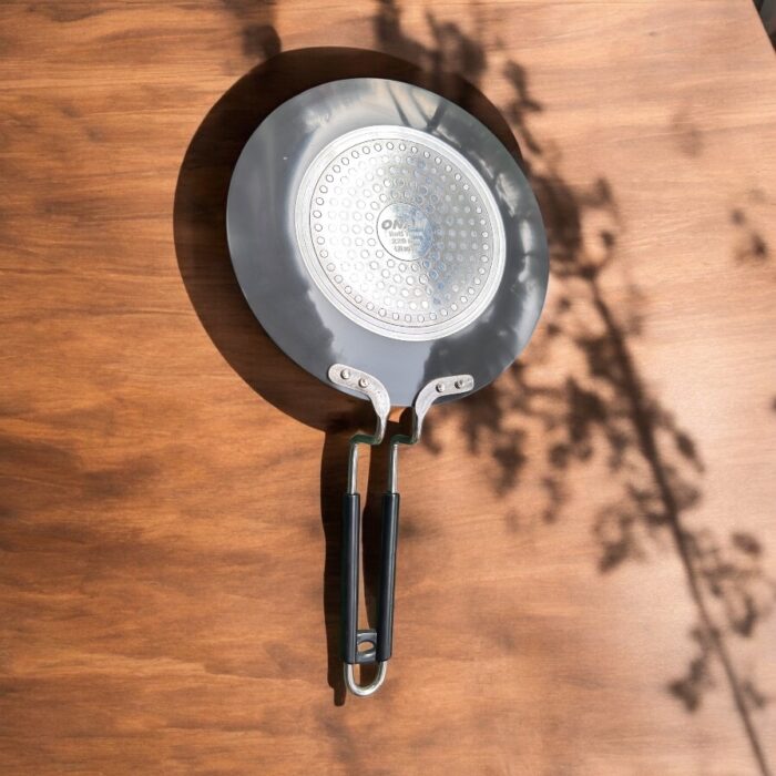 Close-up of Onam 220 mm non-stick roti tawa with induction-compatible base and thick 4.06 mm body, ideal for compact kitchens.