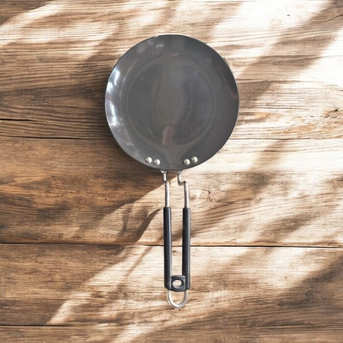 Close-up of Onam 220 mm non-stick roti tawa with induction-compatible base and thick 4.06 mm body, ideal for compact kitchens.