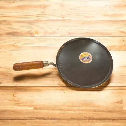 Flat 12-inch seasoned iron tawa with wooden handle for traditional Indian cooking – ideal for rotis, dosas, parathas, and cheelas.