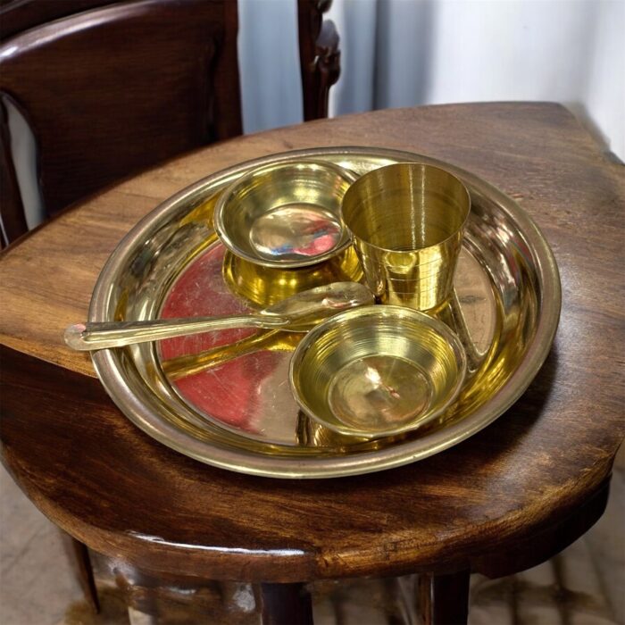 Miniature pure brass dining set with thali, bowls, spoon, and glass – designed for Ladoo Gopal's daily bhog rituals and traditional worship.