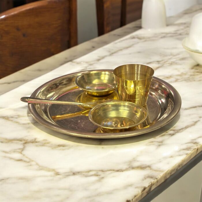 Miniature pure brass dining set with thali, bowls, spoon, and glass – designed for Ladoo Gopal's daily bhog rituals and traditional worship.