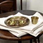 Miniature pure brass dining set with thali, bowls, spoon, and glass – designed for Ladoo Gopal's daily bhog rituals and traditional worship.