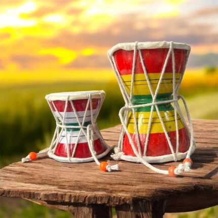 Pair of traditional wooden Damrus with white cords and red detailing, representing the rhythm of Lord Shiva