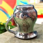 A compact 500 ML stainless steel jug with intricate floral etching, showcasing a traditional Indian design, perfect for daily hydration or pooja rituals.