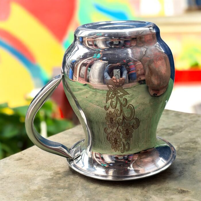 A compact 500 ML stainless steel jug with intricate floral etching, showcasing a traditional Indian design, perfect for daily hydration or pooja rituals.