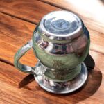 A compact 500 ML stainless steel jug with intricate floral etching, showcasing a traditional Indian design, perfect for daily hydration or pooja rituals.