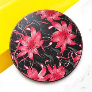 Designer floral print hardboard rolling board chakla with red flowers on a black background, used for roti preparation.