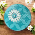 Designer floral print hardboard rolling board chakla with red flowers on a black background, used for roti preparation.