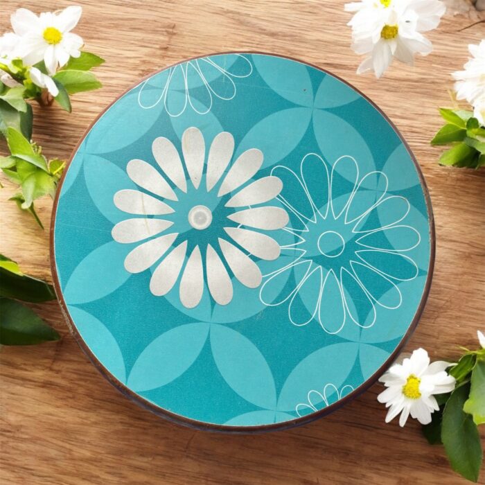 Designer floral print hardboard rolling board chakla with red flowers on a black background, used for roti preparation.