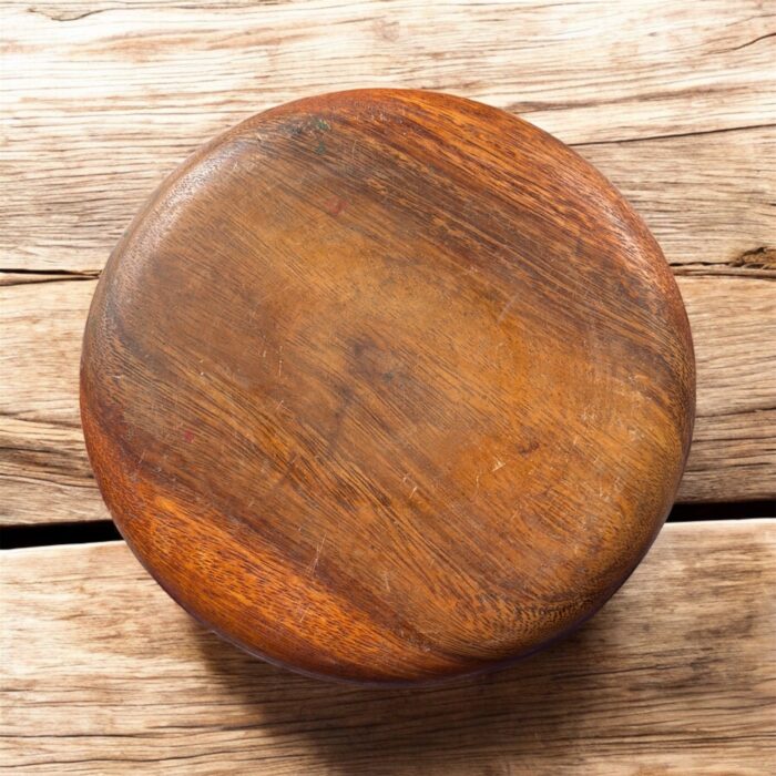 A handcrafted flat wooden chakla made from premium hardwood, designed for rolling rotis, puris, and other Indian breads with ease and stability.