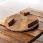 A handcrafted flat wooden chakla made from premium hardwood, designed for rolling rotis, puris, and other Indian breads with ease and stability.