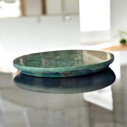 A luxurious black marble chakla with a smooth rolling surface and sturdy anti-slip base, perfect for making rotis, puris, and more in style.