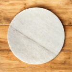 A lightweight white marble roti chakla with a smooth surface, designed for easy handling and effortless rolling of rotis and puris.