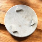 A lightweight white marble roti chakla with a smooth surface, designed for easy handling and effortless rolling of rotis and puris.