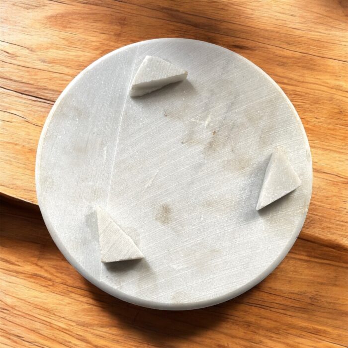 A lightweight white marble roti chakla with a smooth surface, designed for easy handling and effortless rolling of rotis and puris.