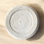 A round, natural white marble roti chakla with a smooth finish, perfect for rolling rotis and puris while adding an elegant touch to any kitchen.