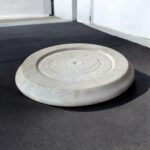 A round, natural white marble roti chakla with a smooth finish, perfect for rolling rotis and puris while adding an elegant touch to any kitchen.