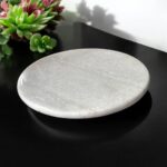 A premium white marble chakla with a non-slip rubber base, designed for stable and smooth rolling of rotis, parathas, and puris.