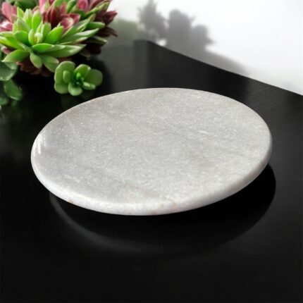 A premium white marble chakla with a non-slip rubber base, designed for stable and smooth rolling of rotis, parathas, and puris.