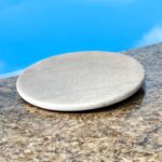 A premium white marble chakla with a non-slip rubber base, designed for stable and smooth rolling of rotis, parathas, and puris.