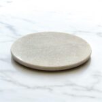 A premium white marble chakla with a non-slip rubber base, designed for stable and smooth rolling of rotis, parathas, and puris.
