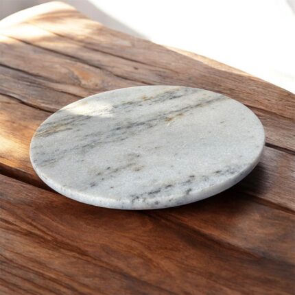 A sleek, round white marble roti chakla with an anti-slip rubber base, designed for smooth and stable rolling of dough in Indian kitchens.