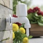 White PVC outdoor garden water tap with long neck and hose connector mounted on wall, ideal for garden watering, car washing and outdoor utility use.